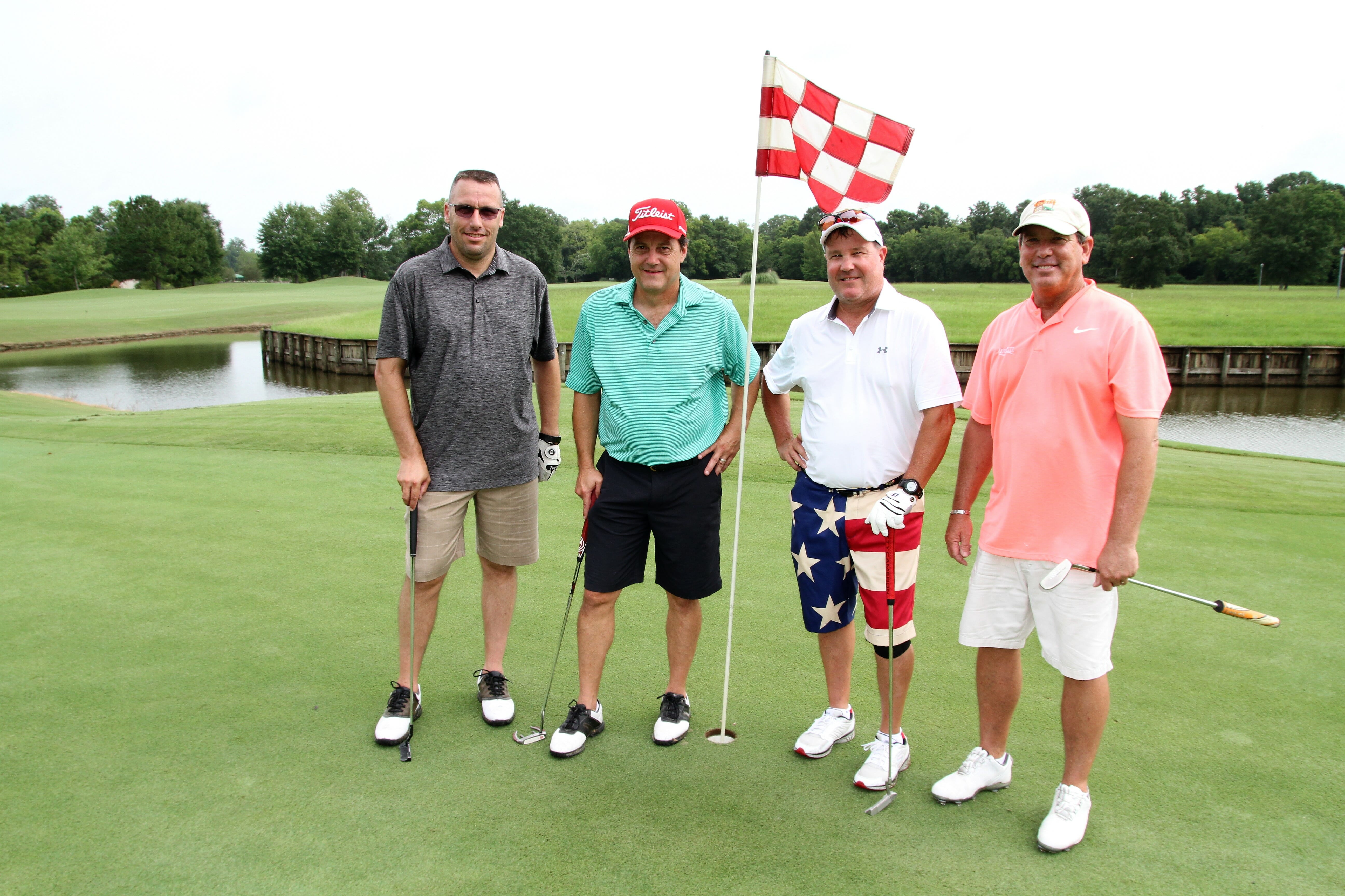 four men golfing