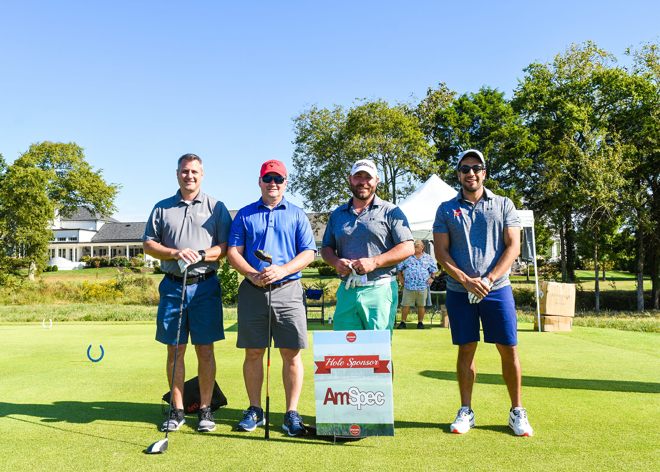 four men posing of golf course