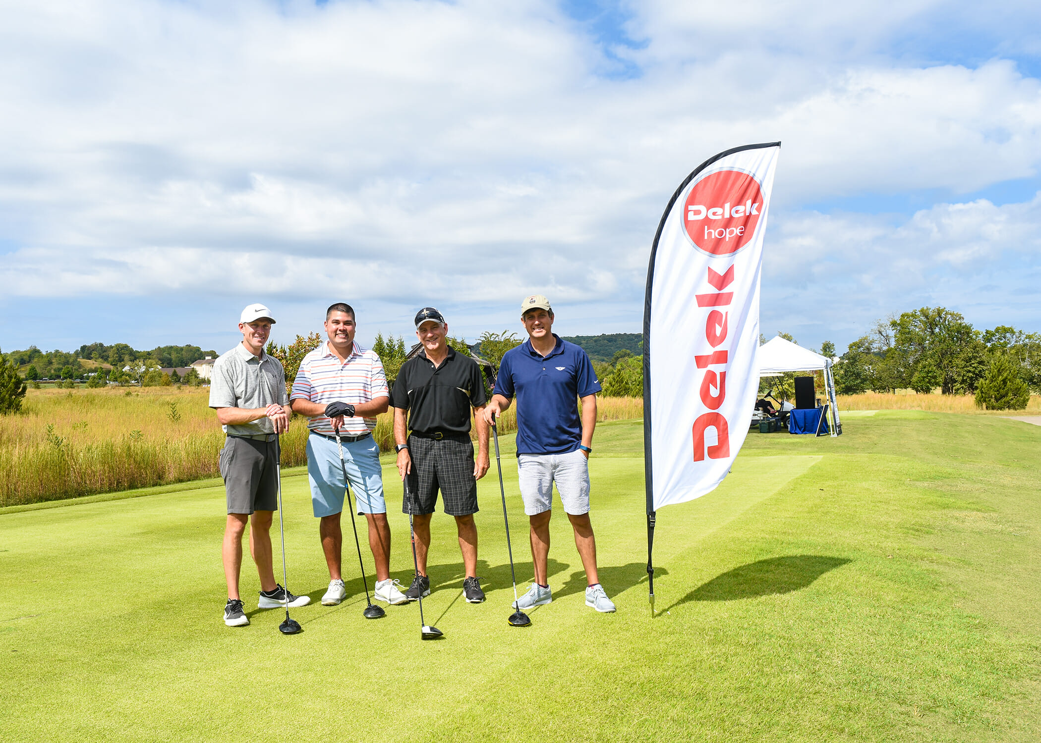 four golfers posing
